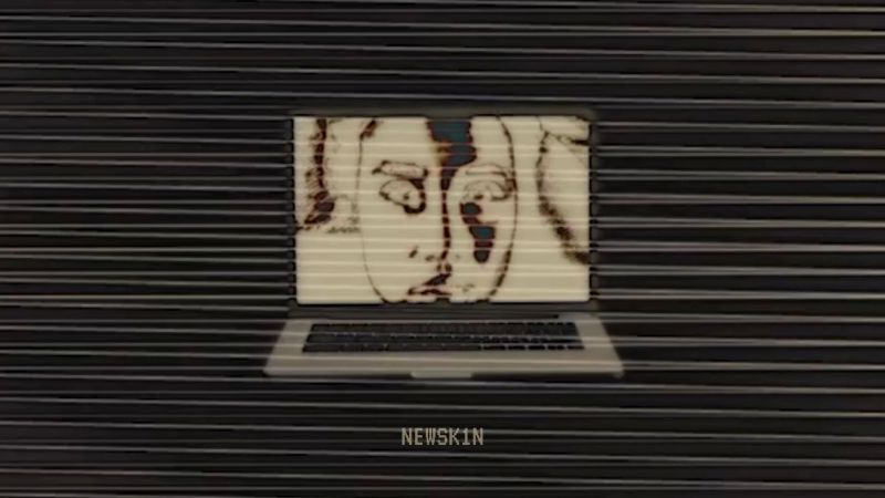 Spooky, inverted image of a face on a laptop screen in a black void with glitchy distortion and the text "NEWSK1N" in an old VCR font.