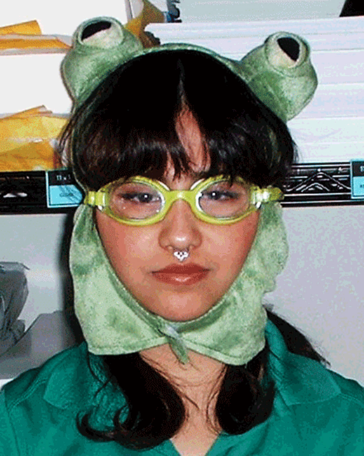 Xia wearing a frog hat and goggles looking deadpan into the camera
