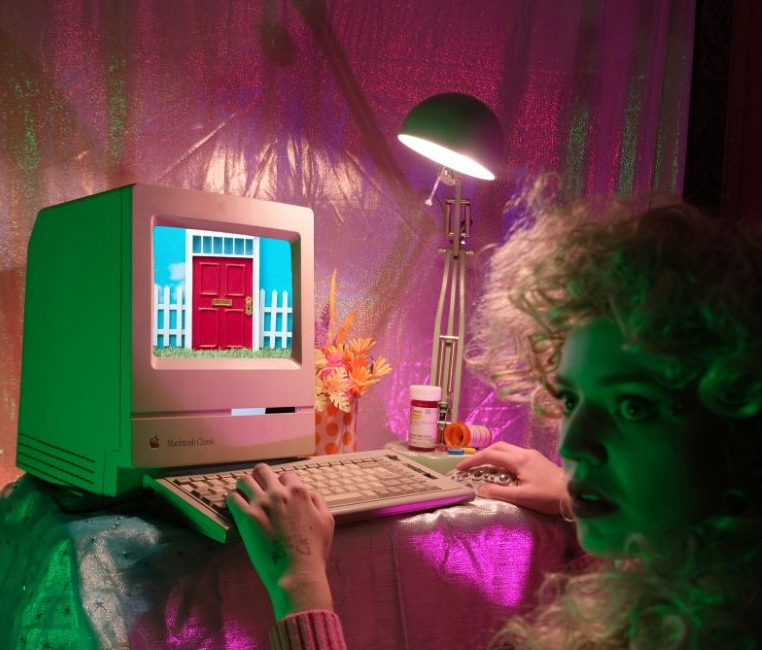 Portrait of Luna Davis as a character using a vintage Macintosh computer.